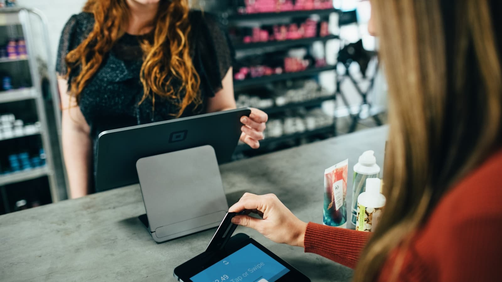 A seller checking orders on a laptop while shopping